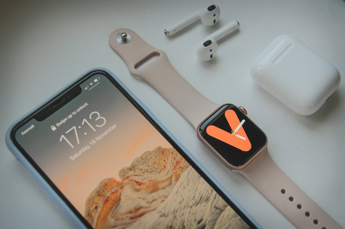 Apple Watch and iPhone laid out on a desk