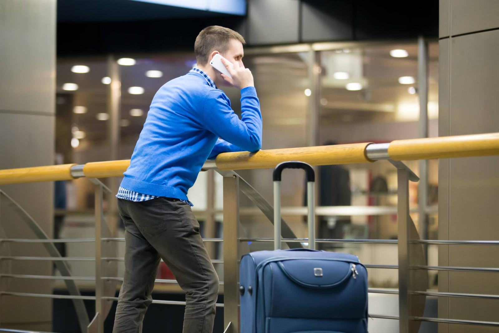 Businessman on a phone call at an airport