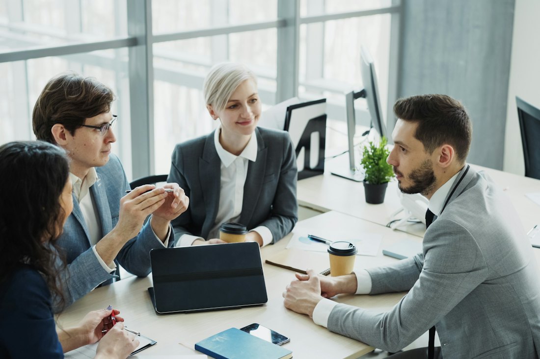 Colleagues in a business meeting around a table