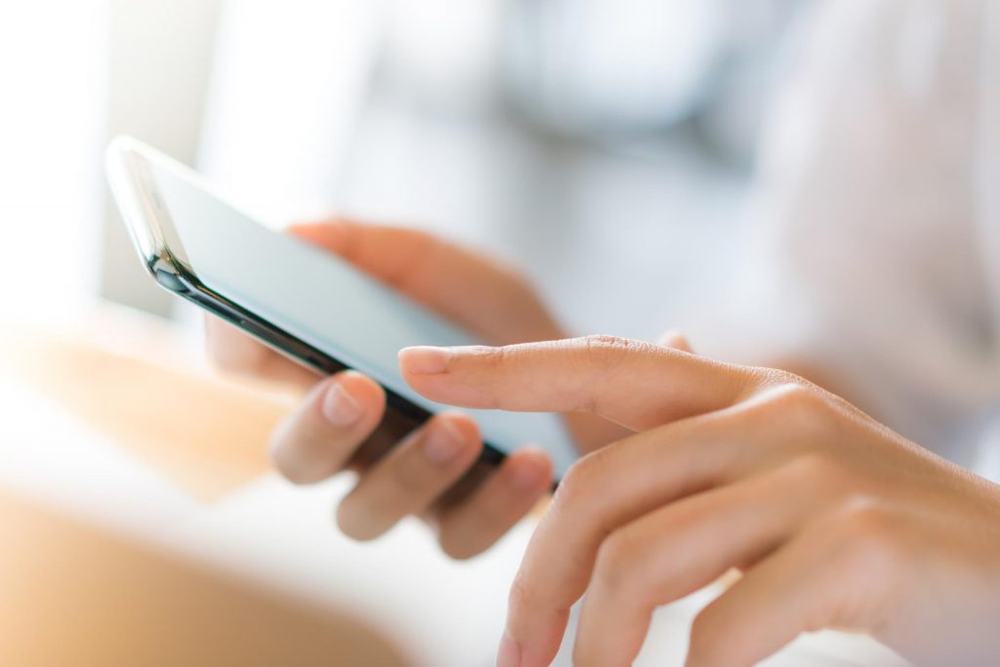 Close-up of hands using a smartphone