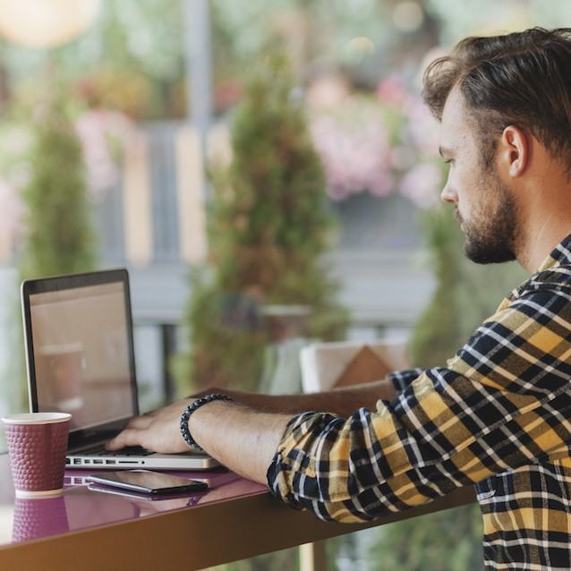 Man working on a laptop outdoors
