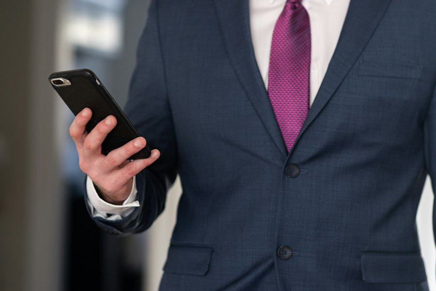 Businessman in a suit holding a smartphone